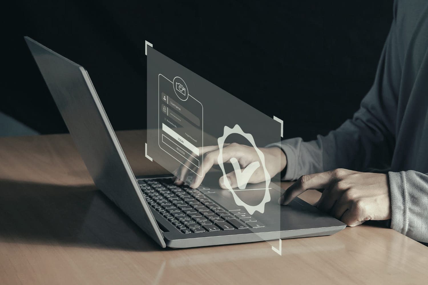 Hands typing on a laptop behind a translucent sign-in verification panel